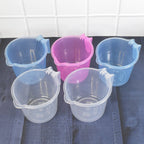 Close-up of a transparent plastic bath mug, showcasing its sturdy design.