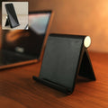Foldable desktop mobile stand placed on kitchen counter for hands-free phone use