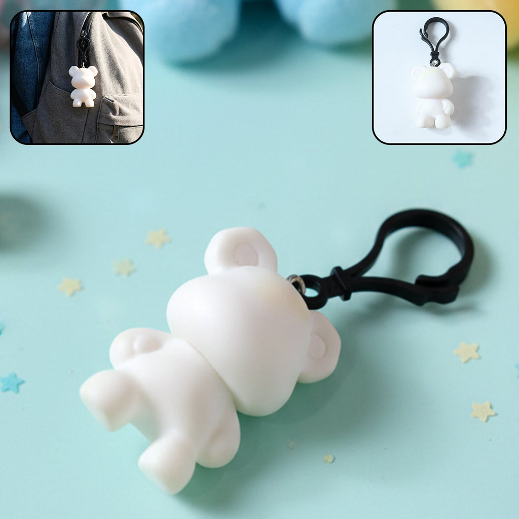 Close-up of bear figure keychain with clip hook attached to backpack strap