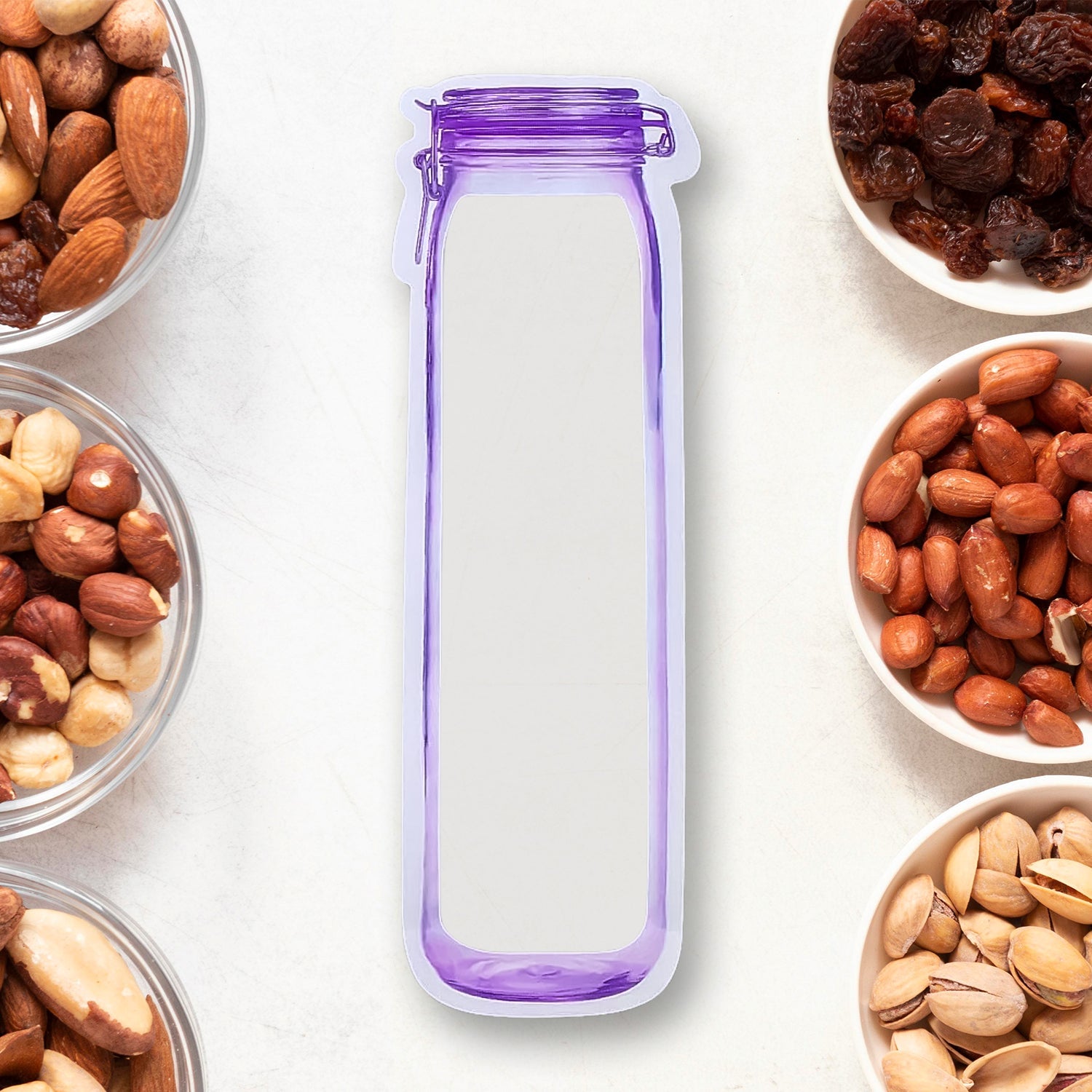 Transparent reusable food storage bag with a bottle shape, filled with colorful snacks.