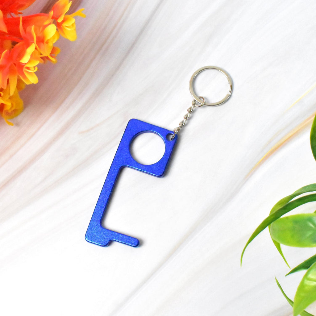 Safe Touch Tool keychain in gold metal with key shape for safe touch-free opening