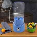 Portable electric juicer with handle and straw for fresh drinks.