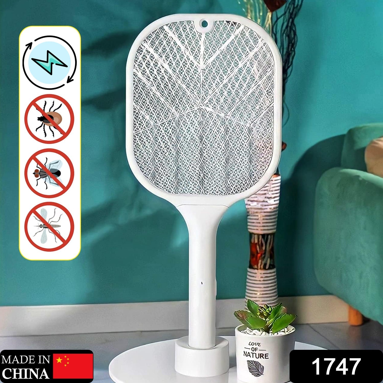 Hand holding the electric fly swatter, ready to zap insects.