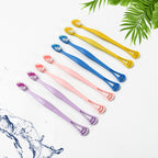 Close-up of the dual-action head of the toothbrush with soft bristles and integrated tongue scraper.