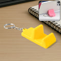 Compact plastic mobile stand keychain holding smartphone in horizontal position