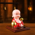 Colourful Solar Buddha Car Ornament with a gently nodding head, perfect for dashboard decor.