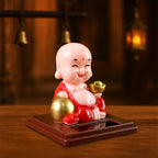 Colourful Solar Buddha Car Ornament with a gently nodding head, perfect for dashboard decor.