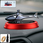 Solar-powered helicopter car air freshener rotating on car dashboard