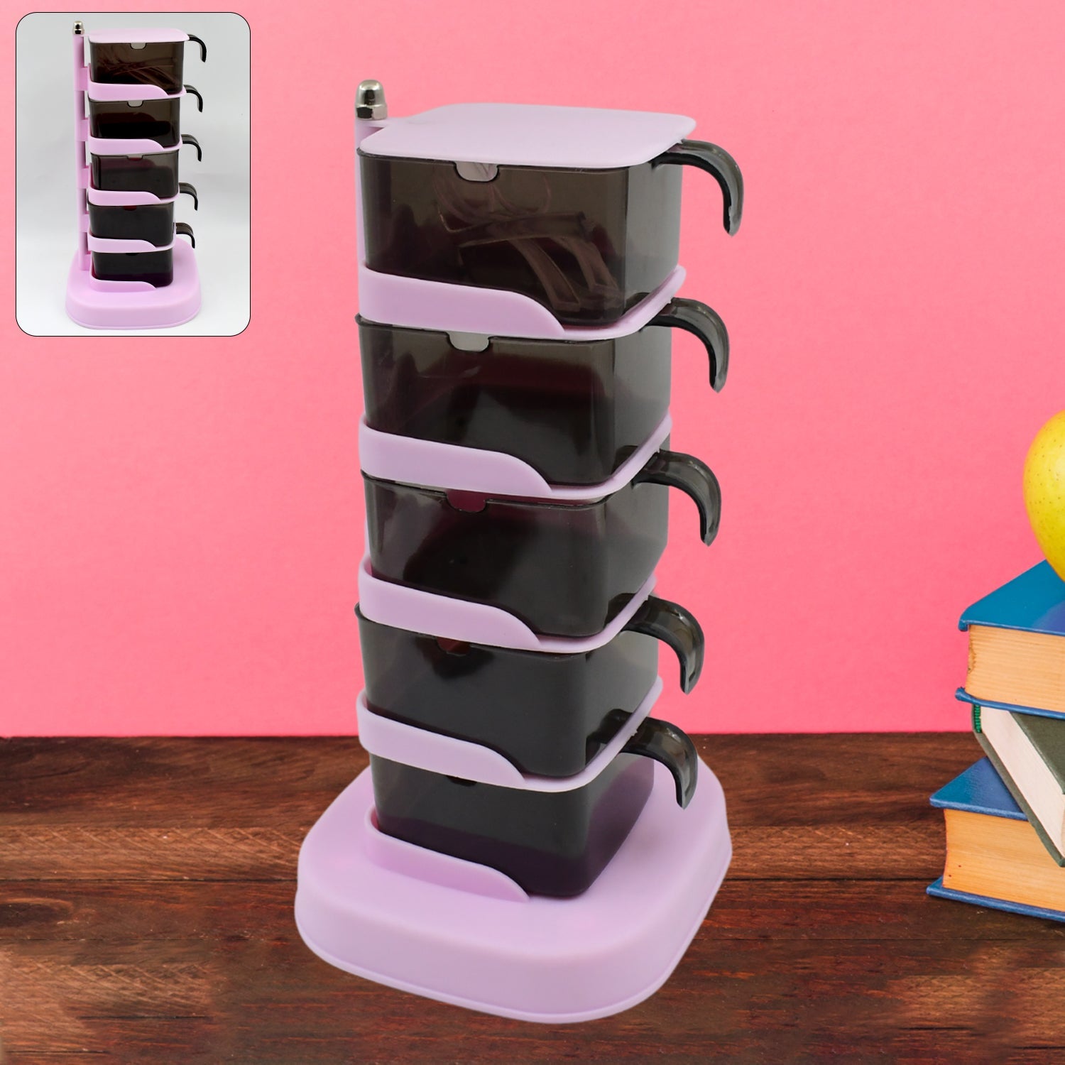 Rotating vertical spice rack with five clear sections and spoons on a kitchen counter.