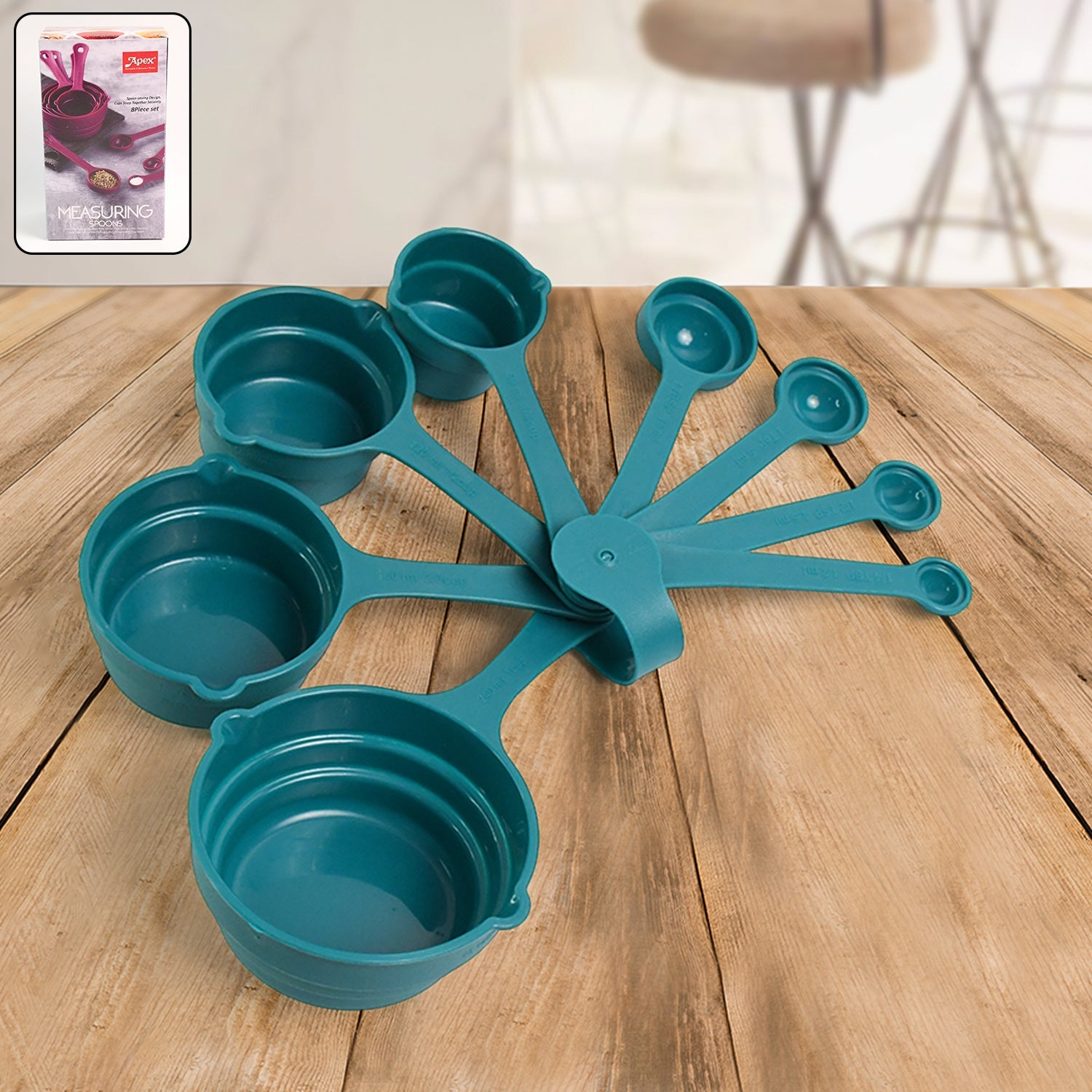 Apex measuring spoons and cups arranged neatly on kitchen table