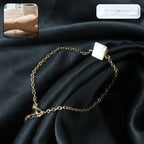 Front view of elegant adjustable chain bracelet featuring square stone charm