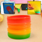 Close-up of a vibrant Rainbow Slinky Toy stretching, showcasing its bright colours.