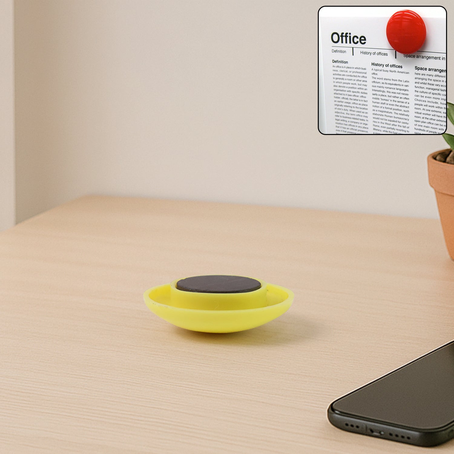 Yellow circular magnetic button gripping whiteboard surface