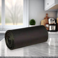 A roll of black garbage bags with a tie-tape for easy and hygienic waste disposal.