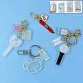 Acrylic and metal keychain featuring a microphone design