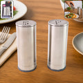 Stainless steel salt and pepper shaker set with brushed finish on kitchen table