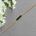 Close-up of a Customized Golden Bracelet with an engraved name.