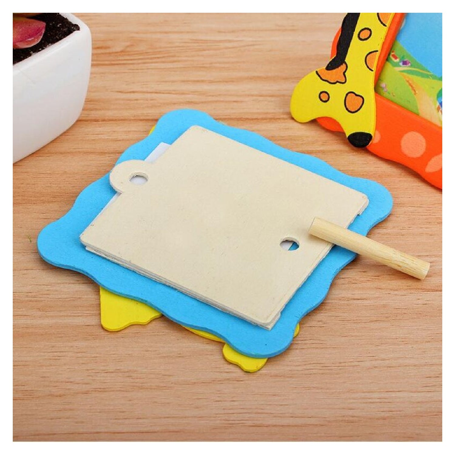 Back view of the baby photo frame showing the easy photo slot and stand for tabletop use.