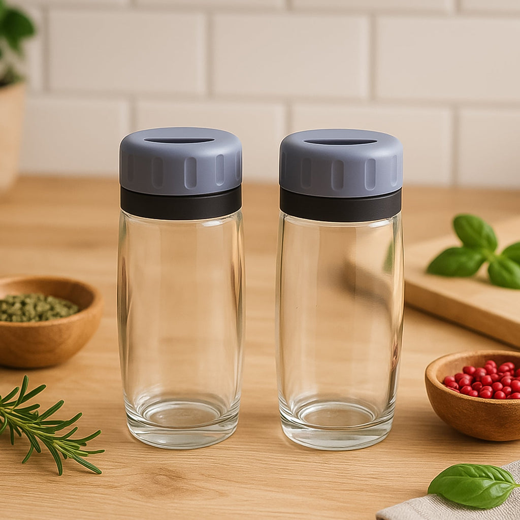 Close-up of transparent acrylic salt and pepper shakers with flip-top lids by Apex