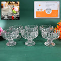 Set of six elegant clear glass ice cream bowls on a crisp white background.