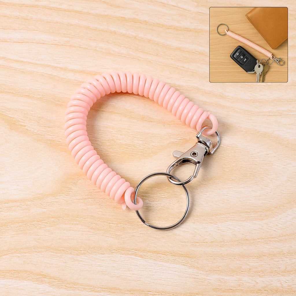 Elastic spiral coil keychain bracelet with metal key ring and clip on white background