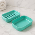 Aqua green plastic soap case with lid showing rectangular design and drainage slits