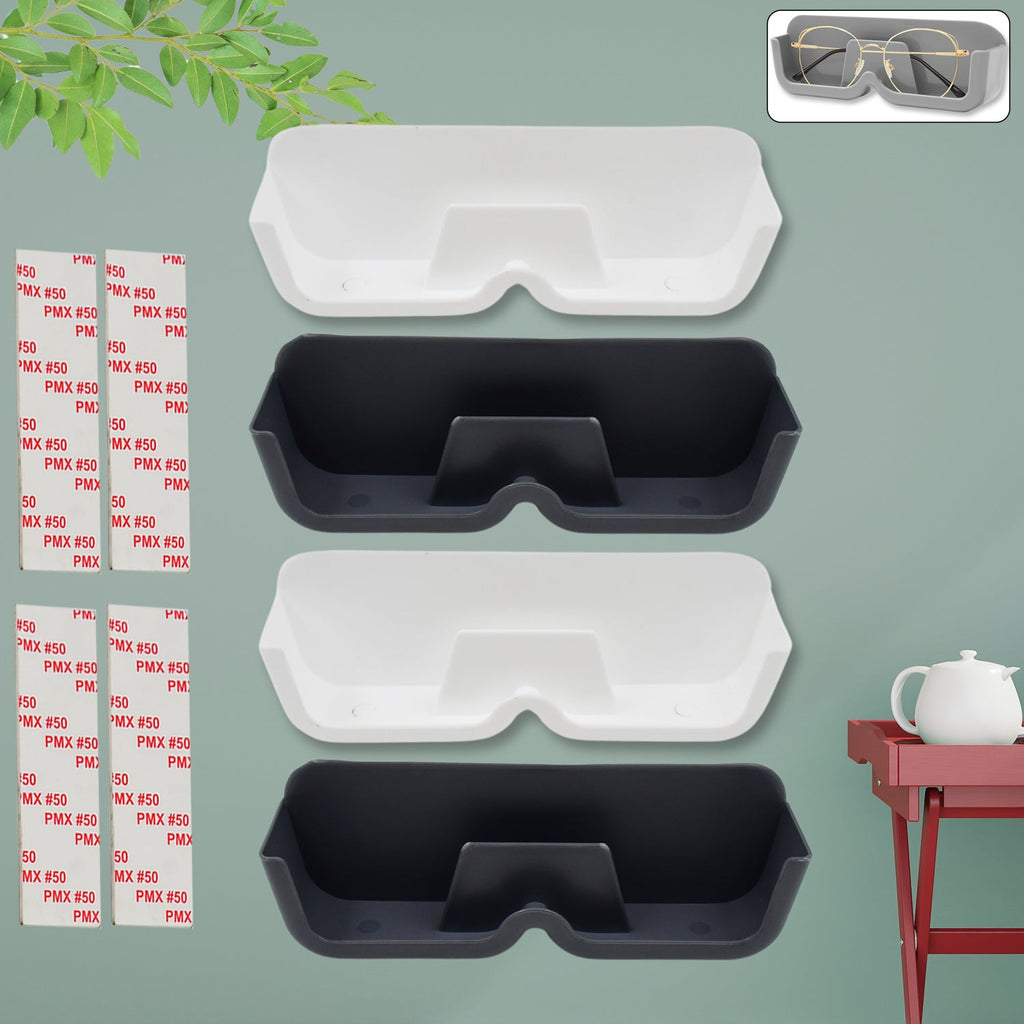 White wall with four adhesive sunglasses holders, displaying various eyewear.