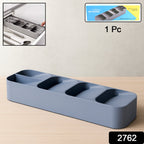 A plastic cutlery tray neatly filled with spoons, forks, and knives in a kitchen drawer.