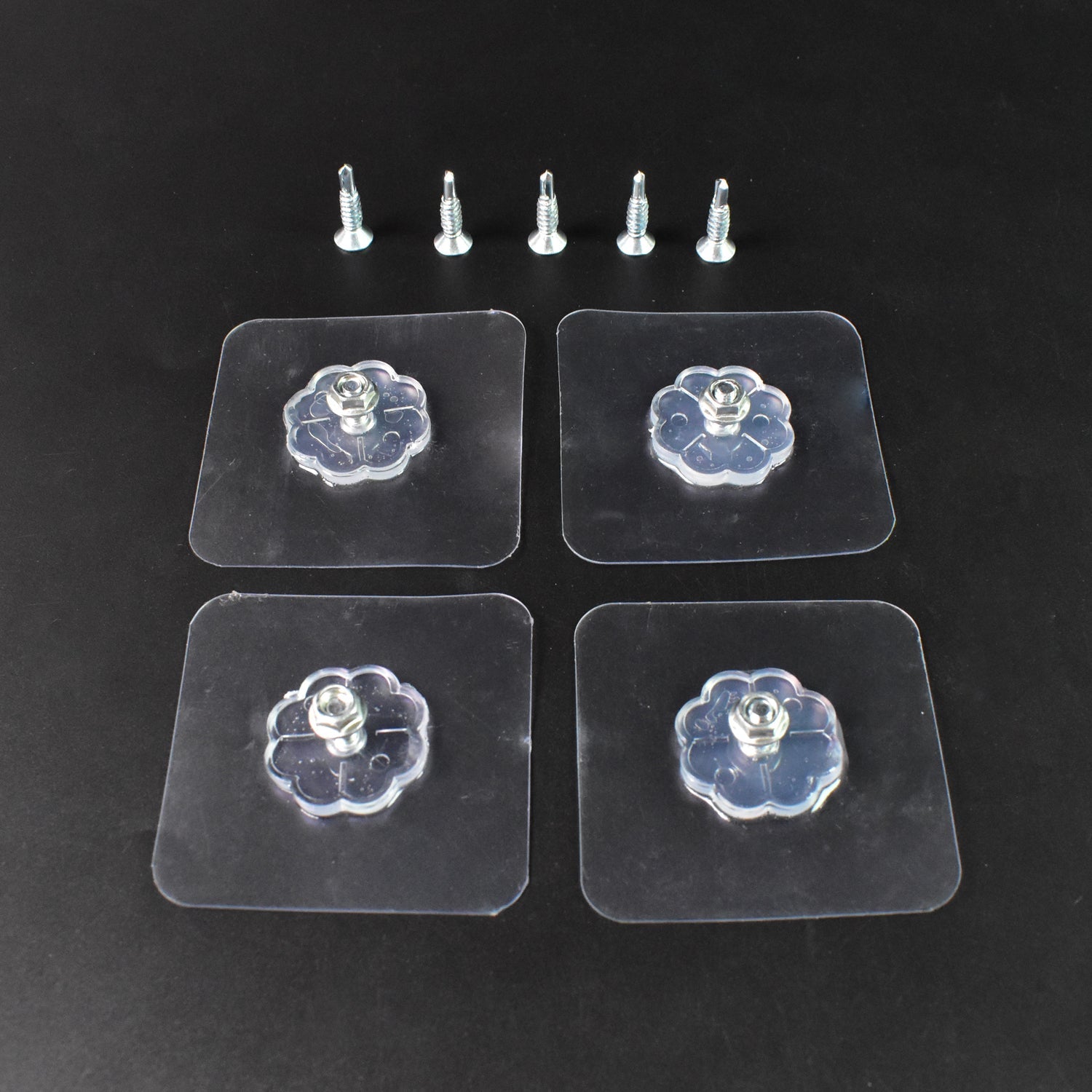 Set of four heavy-duty self adhesive hooks holding kitchen utensils and a clock.