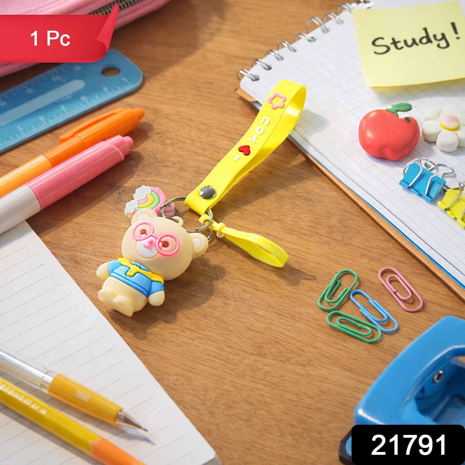 Close-up of teddy bear keychain showcasing cartoon design and vibrant yellow silicone loop strap