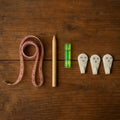 Complete 6-in-1 wall hanging measurement tool kit laid out on table