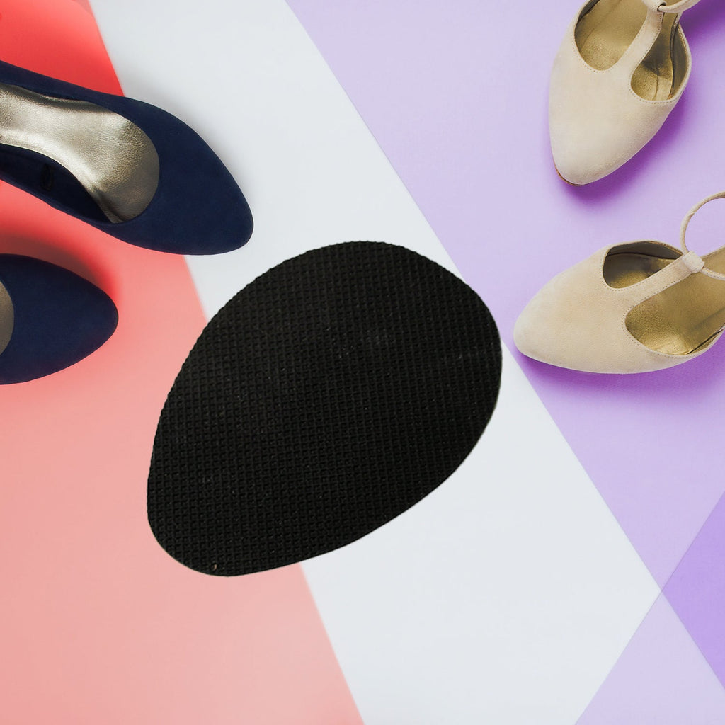 Several pairs of black rubber shoe sole grips neatly arranged on a clean white background.