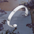Minimalist silver-tone stainless steel bracelet with open-ended design