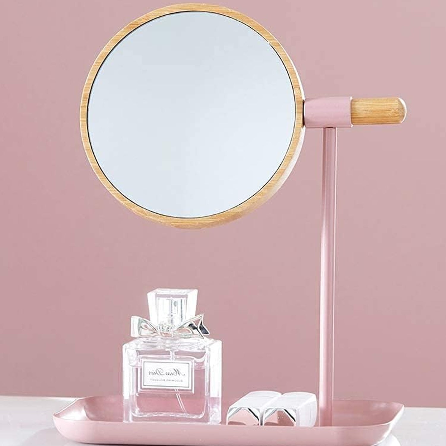 Round tabletop makeup mirror with wooden finish frame on vanity table
