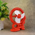 Red Mini Cooling USB Fan on a desk, ready for personal use.
