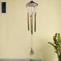 Dragonfly outdoor wind chime with vibrant colours in garden setting
