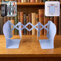 Adjustable book organizer stand expanded on a desk holding books