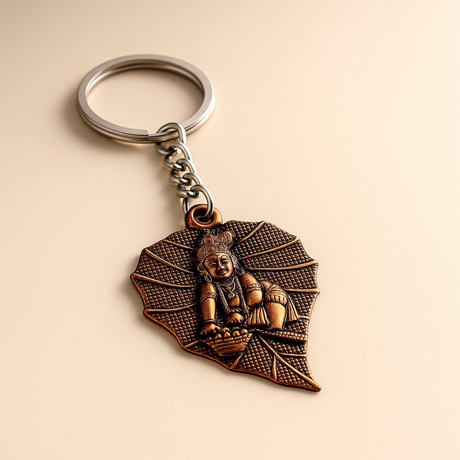 Bal Krishna keychain with antique bronze finish and peepal leaf design