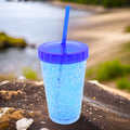 Vibrant plastic reusable sipper tumbler with straw and lid.