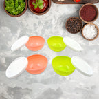 Top view of four small plastic bowls with lids, ready for use.