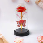 Crystal-clear plastic dome enclosing LED eternal rose with butterfly accent