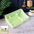 Green multi-section desk organizer storage tray on desk organizing office supplies