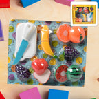 Close-up of vibrant sliceable toy fruits: apple, orange, and banana with velcro.
