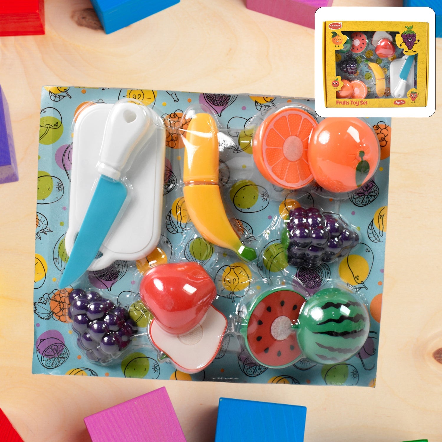 Close-up of vibrant sliceable toy fruits: apple, orange, and banana with velcro.