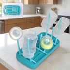 Baby feeding bottle drying rack with hygienic removable drip tray on countertop