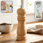 Wooden manual pepper grinder for fresh spice seasoning on kitchen tabletop
