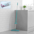 Flat floor cleaning mop with long handle and rectangular mop head on floor