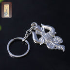 Silver metal Trishul Damru keychain shown on a white background