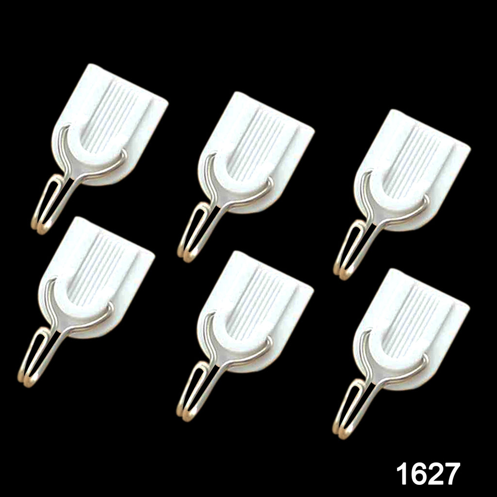 Close-up of a white plastic self-adhesive hook on a wall.