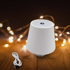 Close-up view of the touch control button on the portable LED bottle lamp.